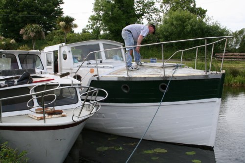 Lady Josephine 3_resize The owner hard at work on a hot day. I know they're a lot of work, but it is nice to see a wooden boat being maintained: there are so many at Shannon Harbour that seem to have been left to rot