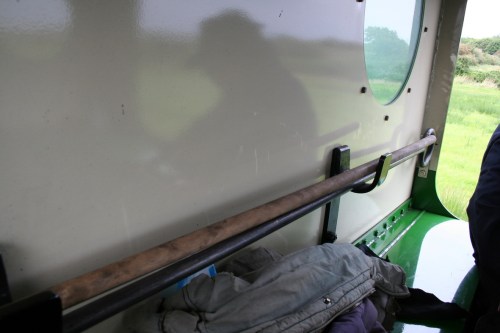 Unidentified metal rod_resize Unidentified metal tool stored across the back of the cab