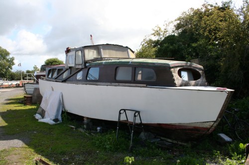 Wooden cruiser being repaired ashore at Lowtown 1_resize Wooden cruiser with sliding canopy (bow view)