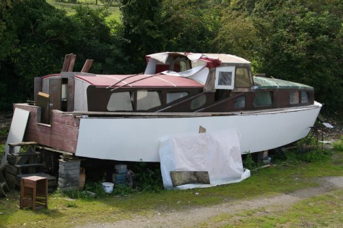 Wooden cruiser being repaired ashore at Lowtown 2_resize Wooden cruiser with sliding canopy (stern view)