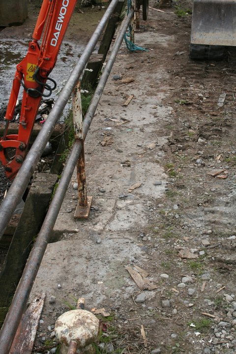 The west side of the dock with an old railing (and bollard on the outside)