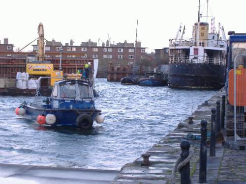 small boat towing large dumb barge (Paul Quinn)